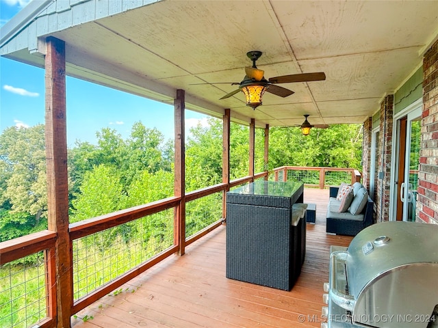 wooden deck featuring a grill and ceiling fan