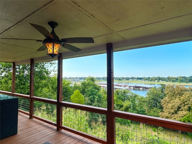 wooden terrace with ceiling fan and a water view