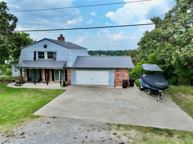 view of front of home with a front lawn, a garage, and covered porch