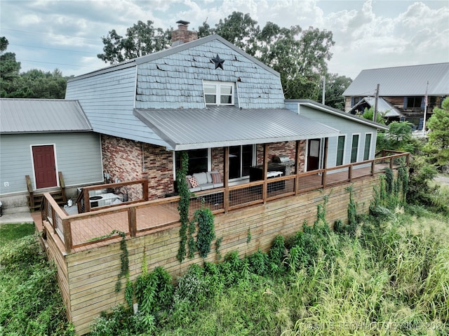 rear view of house featuring an outdoor hangout area