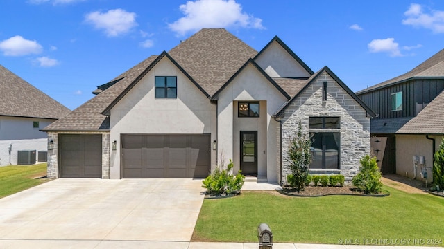 view of front of home featuring central AC, a garage, and a front lawn