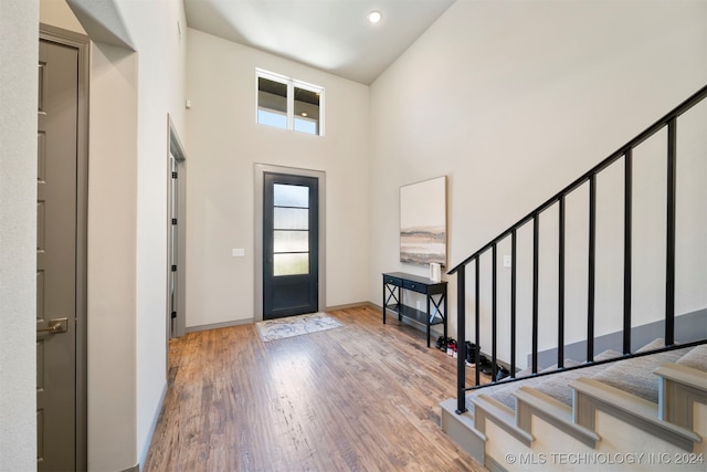 foyer entrance featuring a high ceiling and hardwood / wood-style flooring