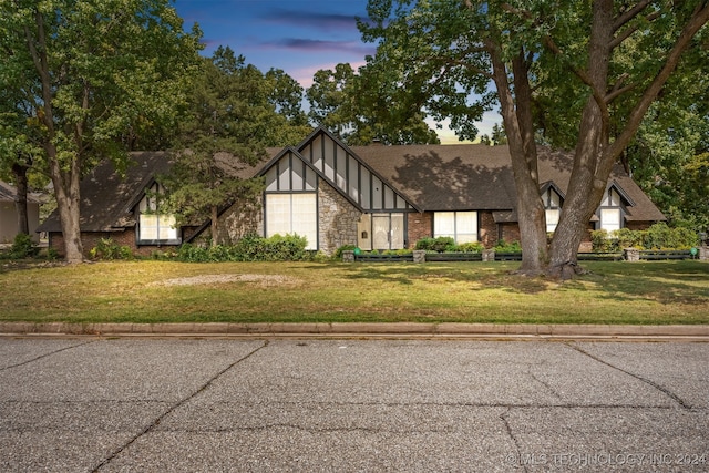 tudor home with a yard