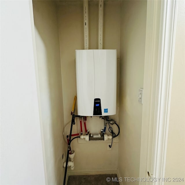 utility room with tankless water heater