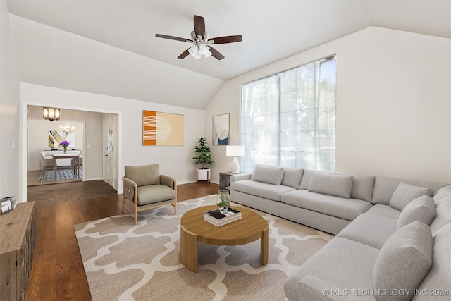 living room with hardwood / wood-style flooring, ceiling fan with notable chandelier, and lofted ceiling