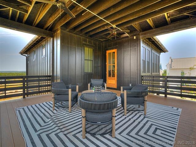 wooden deck with a ceiling fan