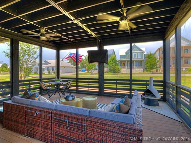 sunroom / solarium with a residential view and a hot tub