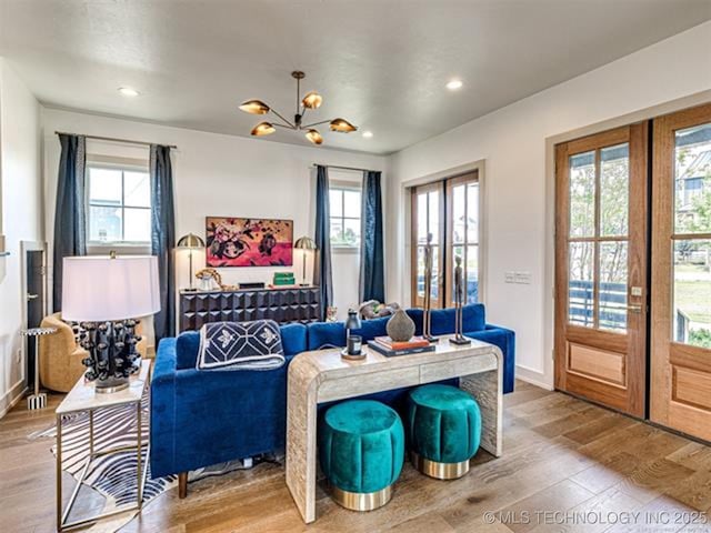 46 Redbud St, Carlton Landing, OK 74432 - living room featuring french doors, plenty of natural light, wood finished floors, a chandelier, and recessed lighting
