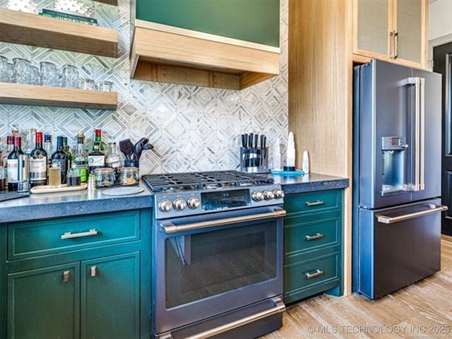 46 Redbud St, Carlton Landing, OK 74432 - kitchen with stainless steel appliances, light wood-type flooring, backsplash, dark countertops, and green cabinetry