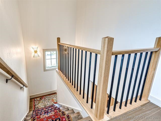 stairway featuring baseboards and wood finished floors