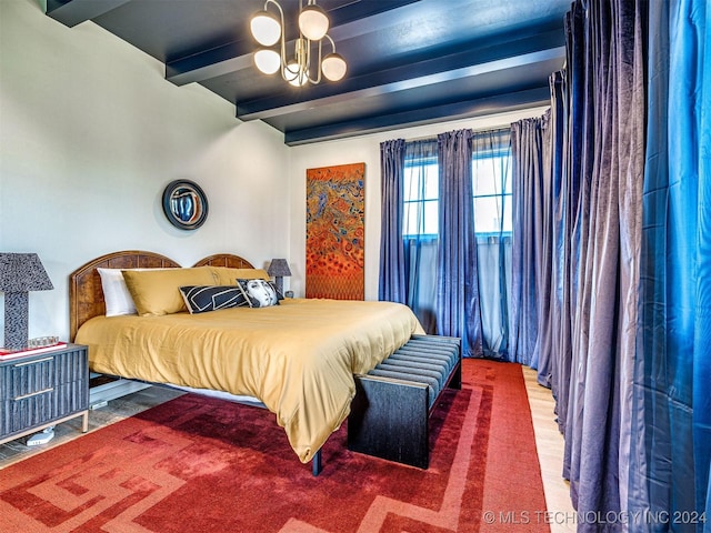 bedroom with beam ceiling and a notable chandelier