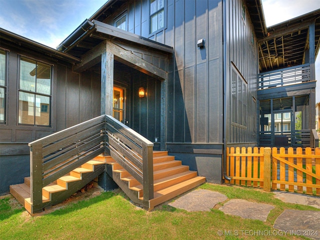 property entrance featuring board and batten siding