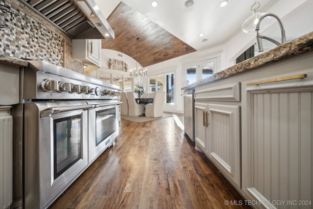 kitchen with white cabinets, lofted ceiling, premium range hood, range with two ovens, and dark wood-type flooring