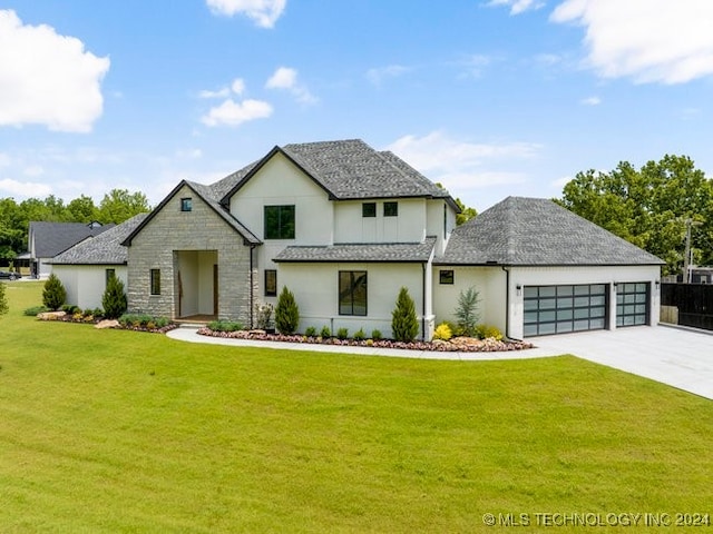 view of front facade with a garage and a front lawn