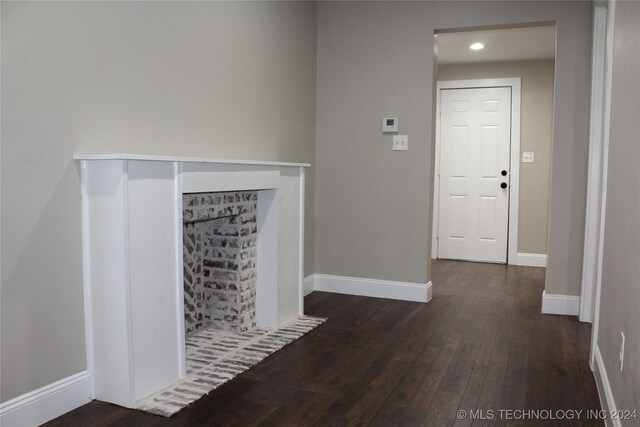 unfurnished living room featuring dark hardwood / wood-style flooring