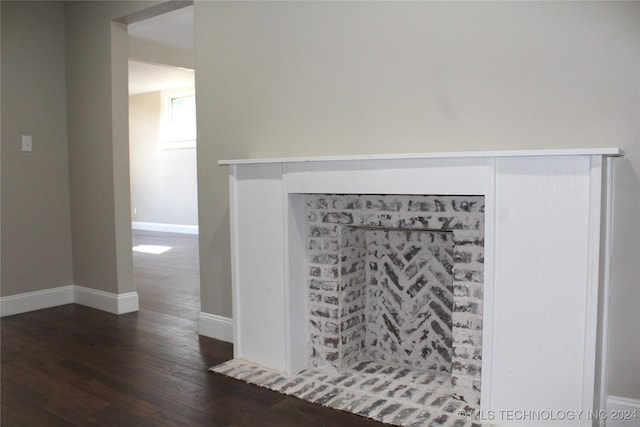 room details featuring baseboards and wood finished floors