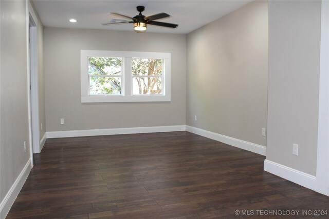 empty room with dark wood-type flooring and ceiling fan