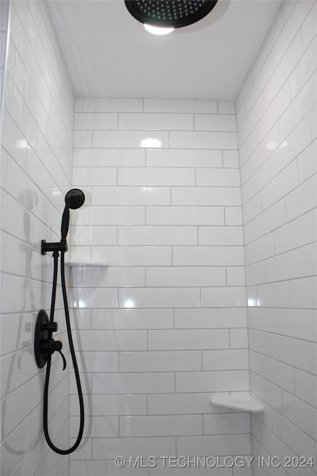 full bathroom with a tile shower