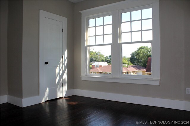 spare room with dark hardwood / wood-style flooring