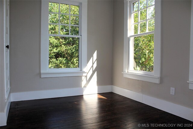 spare room featuring dark hardwood / wood-style flooring