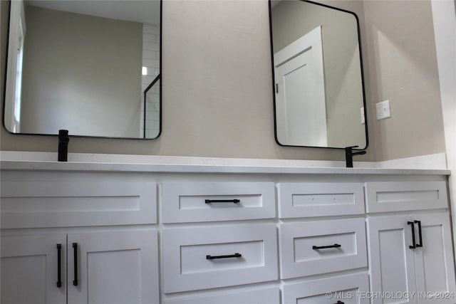 bathroom featuring double vanity and a sink