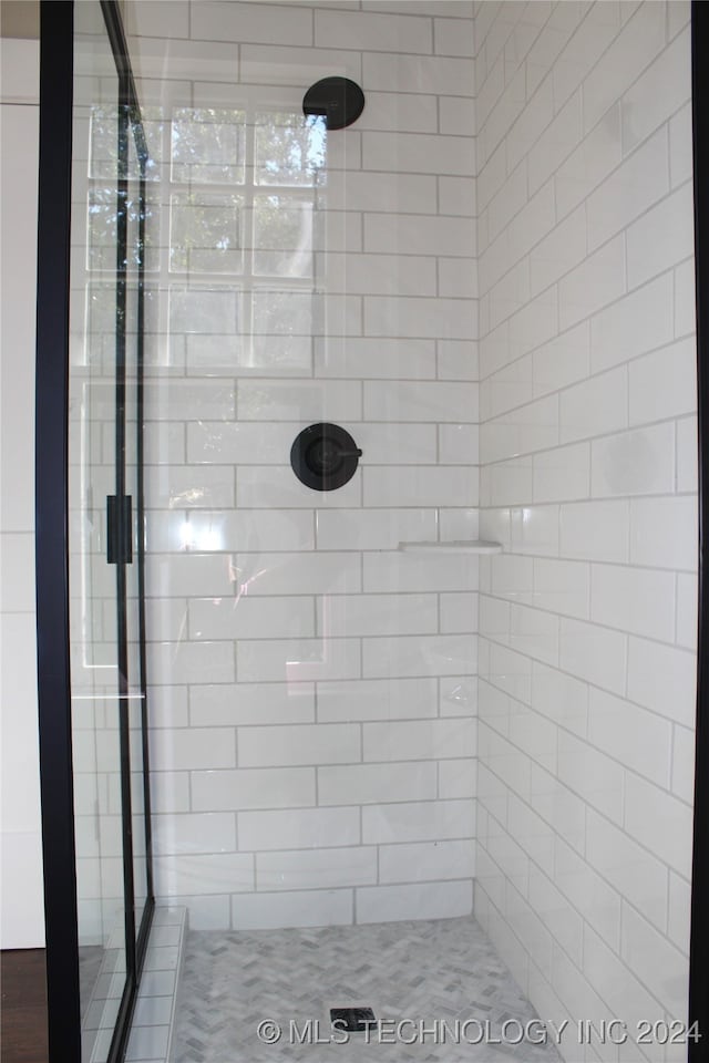 bathroom with tiled shower