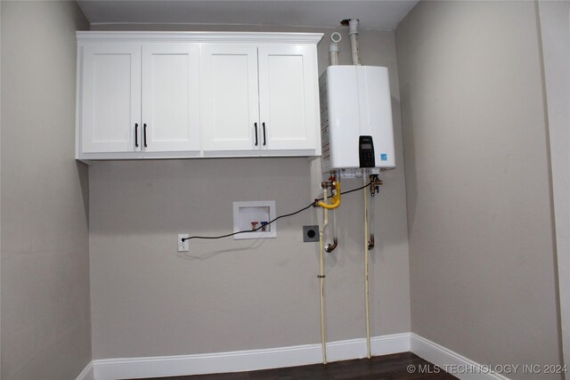 laundry area featuring cabinets, washer hookup, tankless water heater, dark wood-type flooring, and hookup for an electric dryer