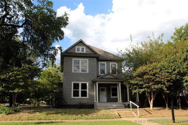 view of front of property with a front lawn and a porch