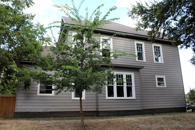 view of side of property with fence