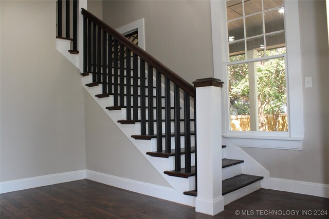 staircase with hardwood / wood-style floors