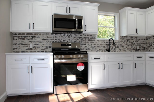 kitchen with white cabinetry, tasteful backsplash, dark wood-style floors, and appliances with stainless steel finishes