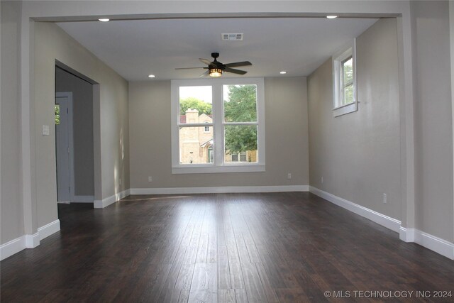 unfurnished room featuring ceiling fan, plenty of natural light, and dark hardwood / wood-style flooring