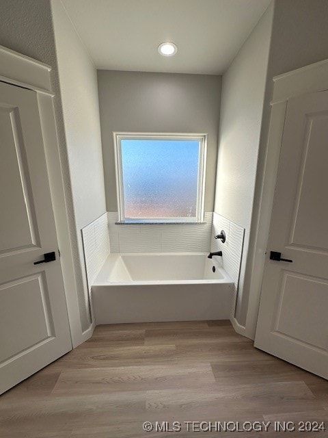 bathroom featuring hardwood / wood-style floors and a bathtub