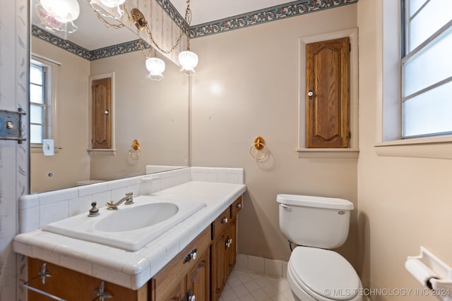 bathroom featuring vanity, toilet, and tile patterned flooring