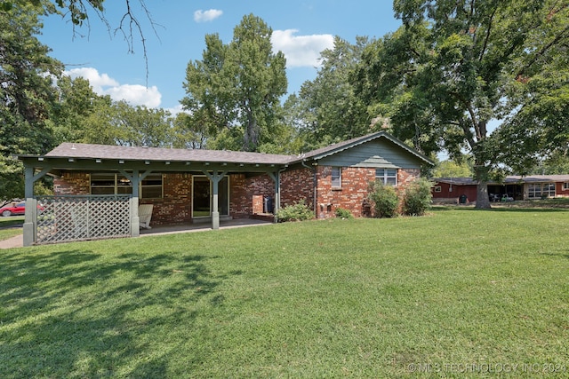 view of front of property with a patio area and a front lawn