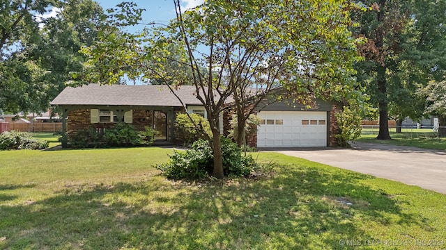 ranch-style house featuring a garage and a front lawn