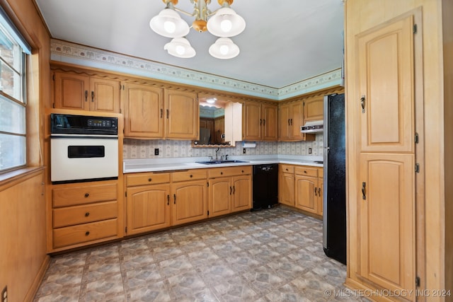 kitchen with white oven, an inviting chandelier, black dishwasher, sink, and decorative backsplash