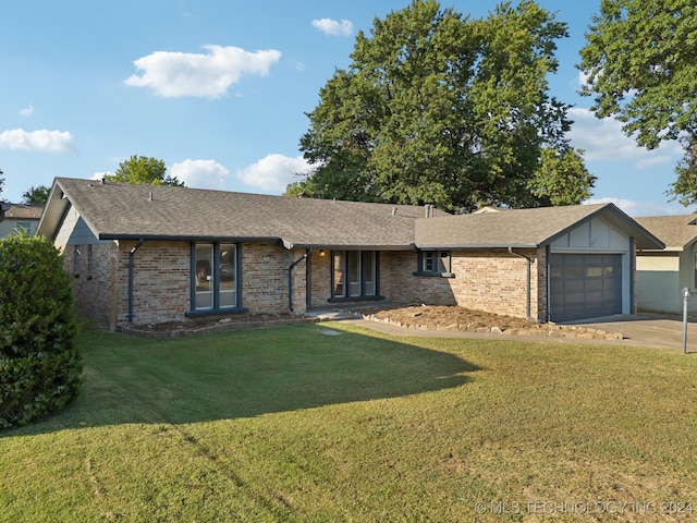 single story home with a front yard and a garage