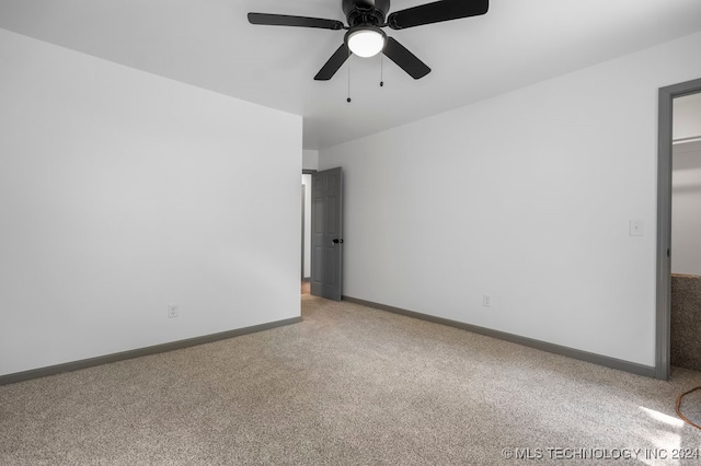 unfurnished room featuring light colored carpet and ceiling fan