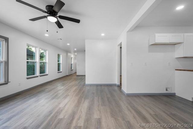 unfurnished living room with ceiling fan and light hardwood / wood-style floors