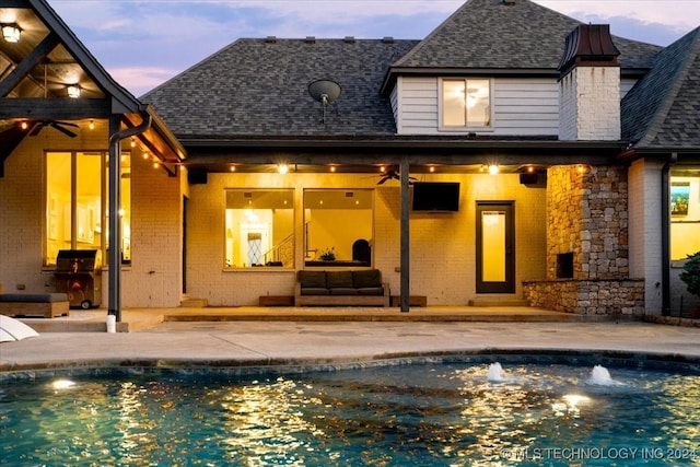 rear view of house featuring a patio, outdoor lounge area, and ceiling fan