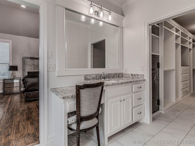 bathroom with crown molding and vanity