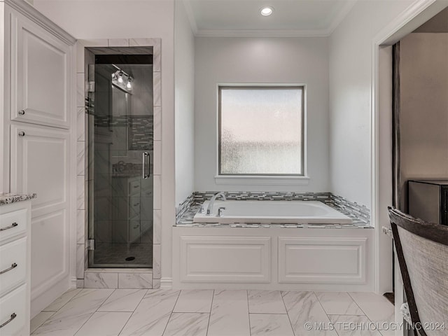 bathroom with ornamental molding and shower with separate bathtub