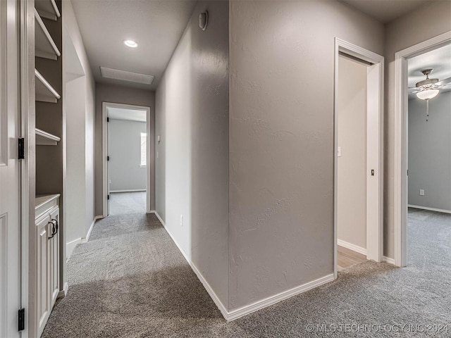 hallway featuring light carpet