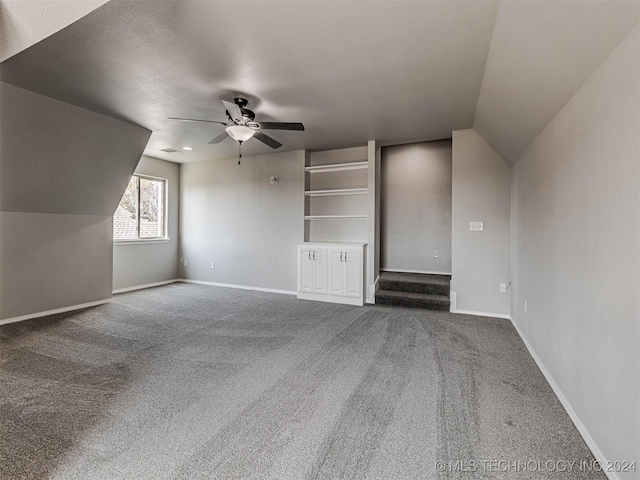 additional living space with ceiling fan, lofted ceiling, and carpet