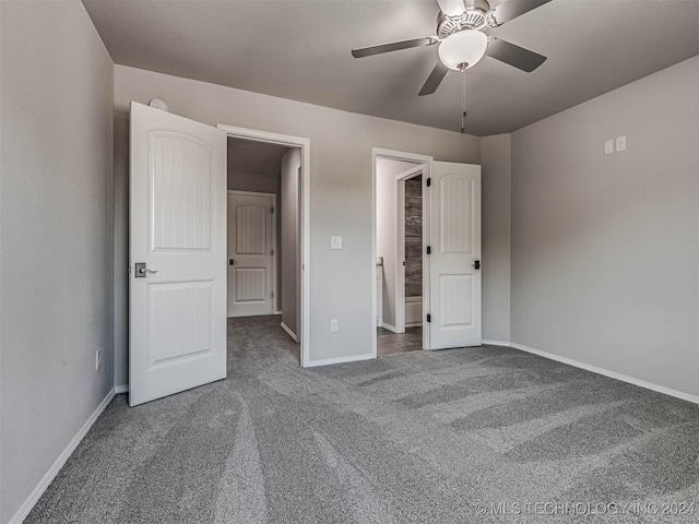 unfurnished bedroom featuring ceiling fan and carpet