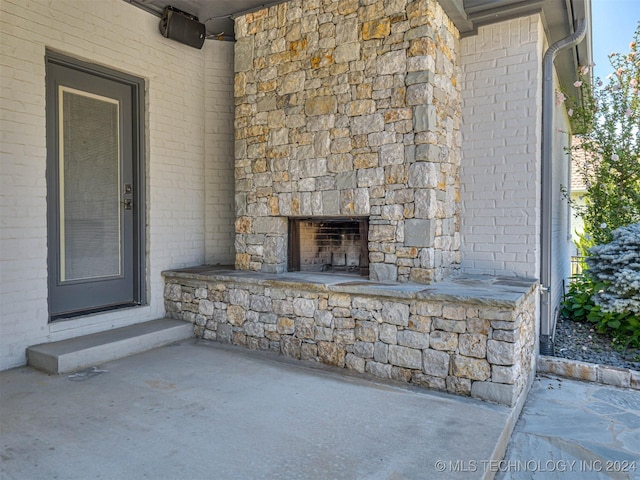 property entrance with an outdoor stone fireplace