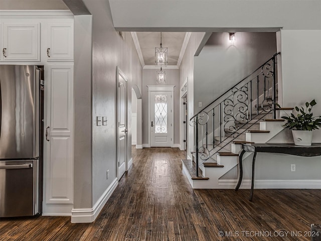 entrance foyer with crown molding and dark wood-type flooring