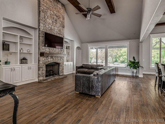 living room featuring dark wood-type flooring, a fireplace, high vaulted ceiling, and beam ceiling