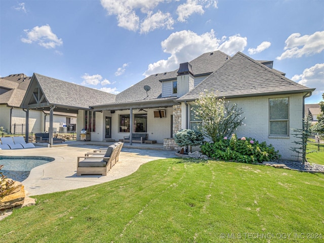 rear view of house with a yard, ceiling fan, and a patio area